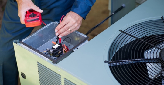 HVAC tech performing repairs on unit