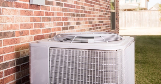 Air conditioner system outside of a brick home
