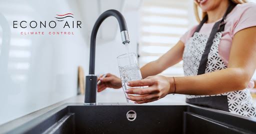 woman filling cup with water
