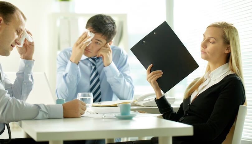 Group of people sweating in meeting