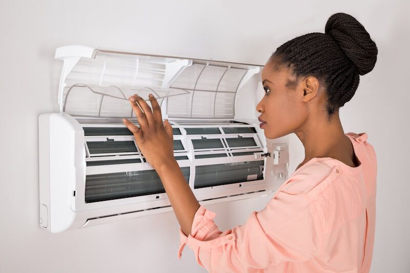 Woman cleaning AC