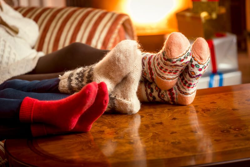 Family Warming Feet at Fireplace
