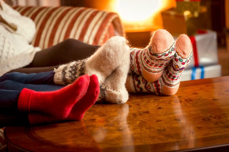 Family Warming Feet at Fireplace