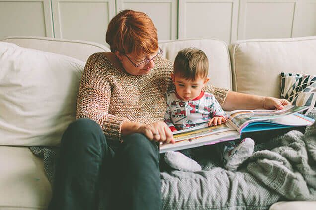 Grandma Toddler Reading Home with Heating